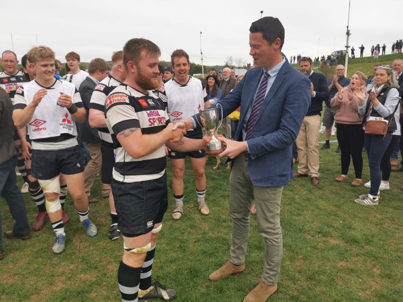 Stow skipper Jim Wood receives  the Cheltenham Combination Senior Cup from MP Alex Chalk last season