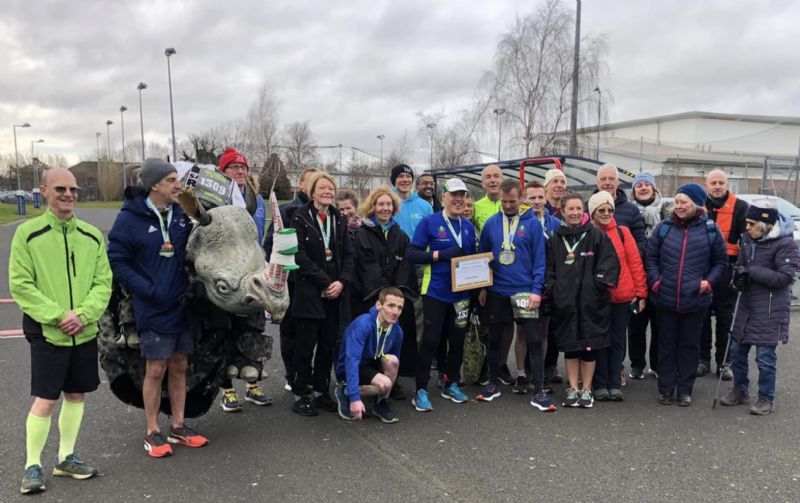 Phillip Howells, centre, surrounded by friends after his 333rd marathon