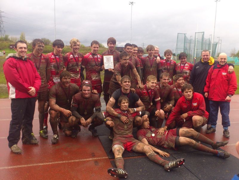 Sam Underhill, squatting down on the left side, celebrates a County Cup win with Longlevens