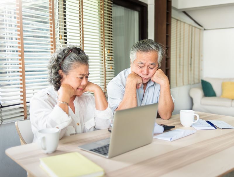 Worried couple looking at pension debts money