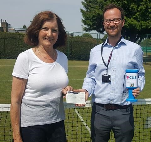 Alison Savage presents a cheque to Richard Smith, head of fundraising for the Focus Research Centre