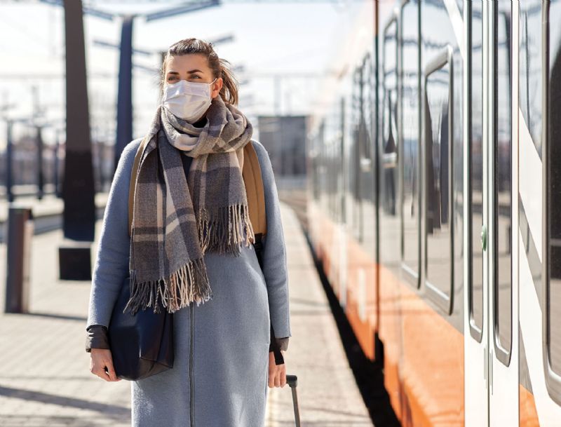 Woman wearing face mask in public train station