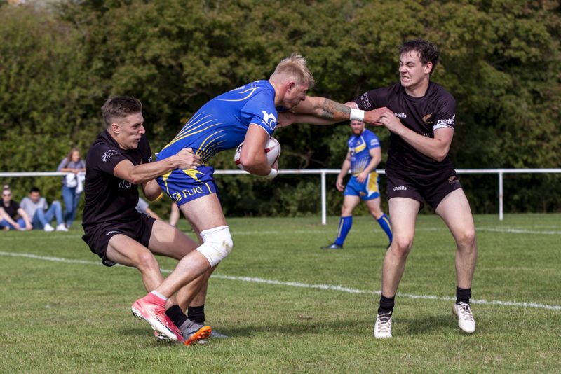 Callum Merrett, left, and Joe Uren try to tie down Telford’s James Derry. Picture, Lewis Mitchell