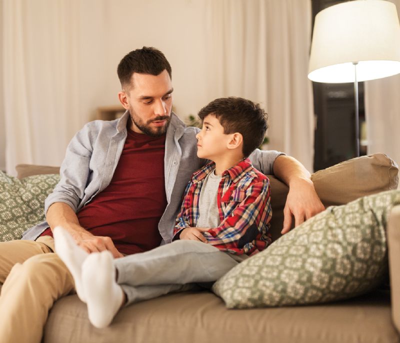 Dad talking with young son about serious issues