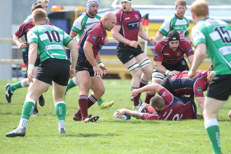 Gloucestershire forwards Tom Anderson, on the ground,  George Angell, on guard, and George Porter joining the ruck