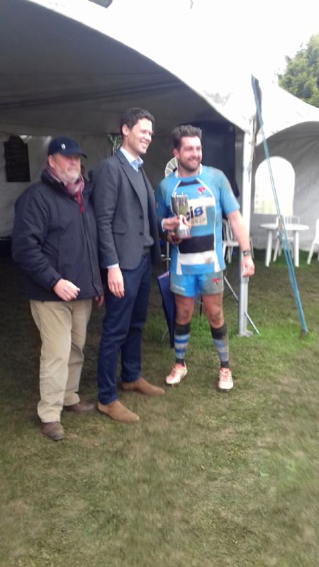 Rich Athey receives the Senior Cup from Alex Chalk. Also pictured is Cheltenham Combination stalwart Malcolm Kedward