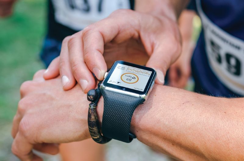 Man looking at fitness watch performance monitoring