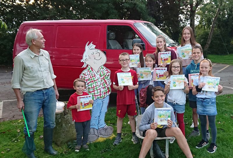 John with Grandad from the books and ten of his grandchildren. 

Right to left, Back row - Sophie, Ella and Katie Smart. Middle row – James Carter and Lucy Smart. Front row – Charlotte, Sienna, Lewis and Max Carter. Henry Carter is in the wheelbarrow (18 month old Amelia Carter wouldn’t stand still)