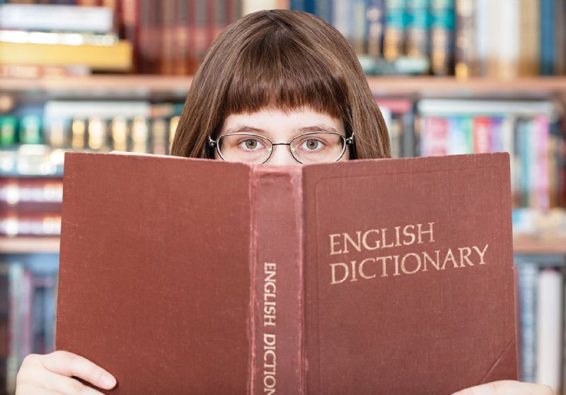 Female student reading English dictionary