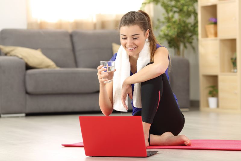 Woman doing online workout fitness class from home